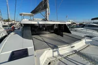 2022 Leopard 42 catamaran docked at marina, featuring spacious deck and modern design.