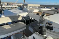 Modern Leopard 42 catamaran deck, 2022 model, featuring seating and sailing equipment at a marina.