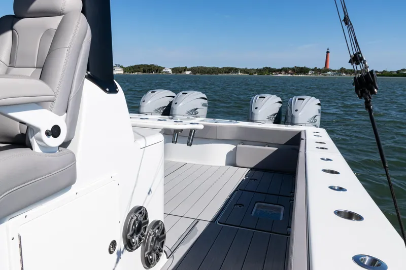  Yacht Photos Pics 2024 Freeman 47 boat interior with multiple engines, lighthouse in background.