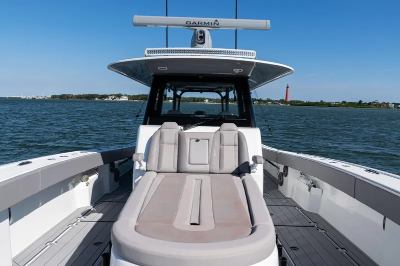  Yacht Photos Pics 2024 Freeman 47 boat with spacious deck and seating, cruising on open water.