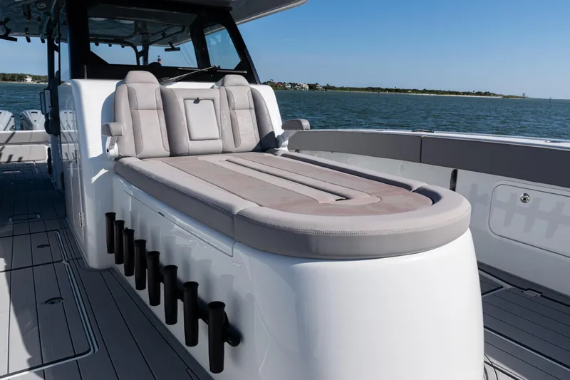  Yacht Photos Pics 2024 Freeman 47 boat interior with luxurious seating and rod holders, on calm waters.