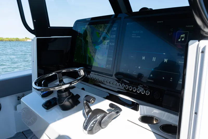  Yacht Photos Pics 2024 Freeman 47 boat dashboard with navigation and audio controls, steering wheel, and dual screens.
