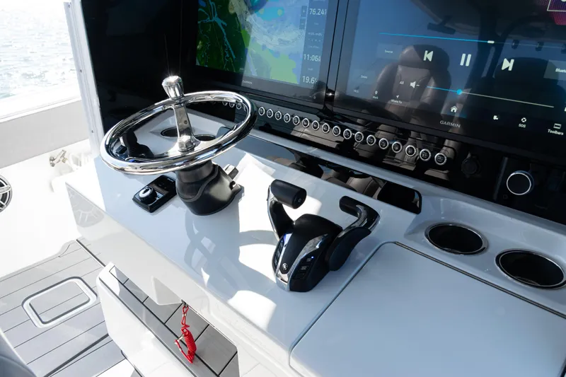  Yacht Photos Pics 2024 Freeman 47 boat dashboard with steering wheel, touchscreen displays, and control panel.