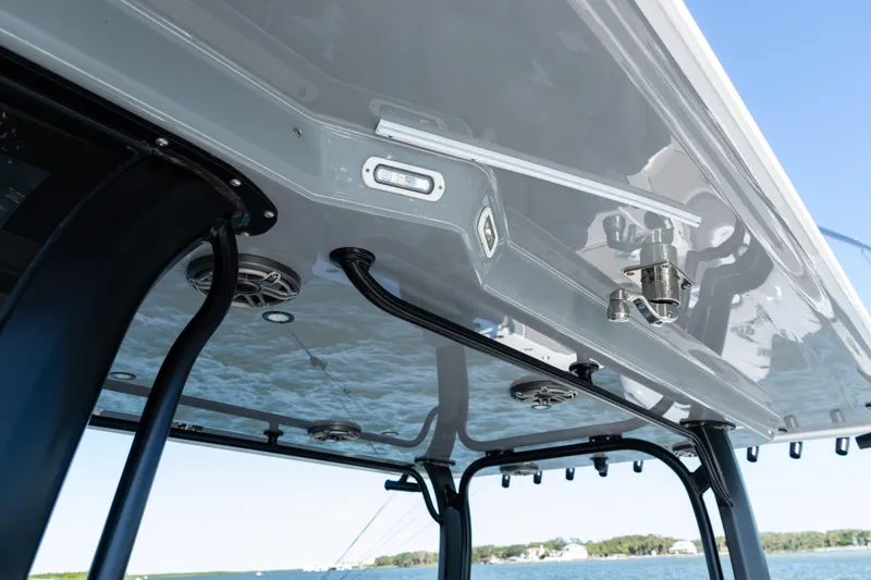  Yacht Photos Pics 2024 Freeman 47 boat canopy with speakers and lighting, overlooking a scenic water view.