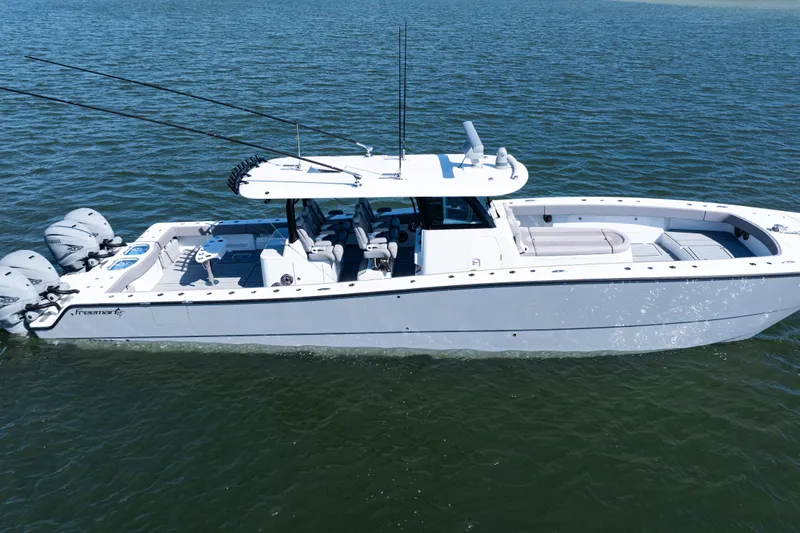  Yacht Photos Pics 2024 Freeman 47 boat on water, featuring sleek design and multiple outboard engines.