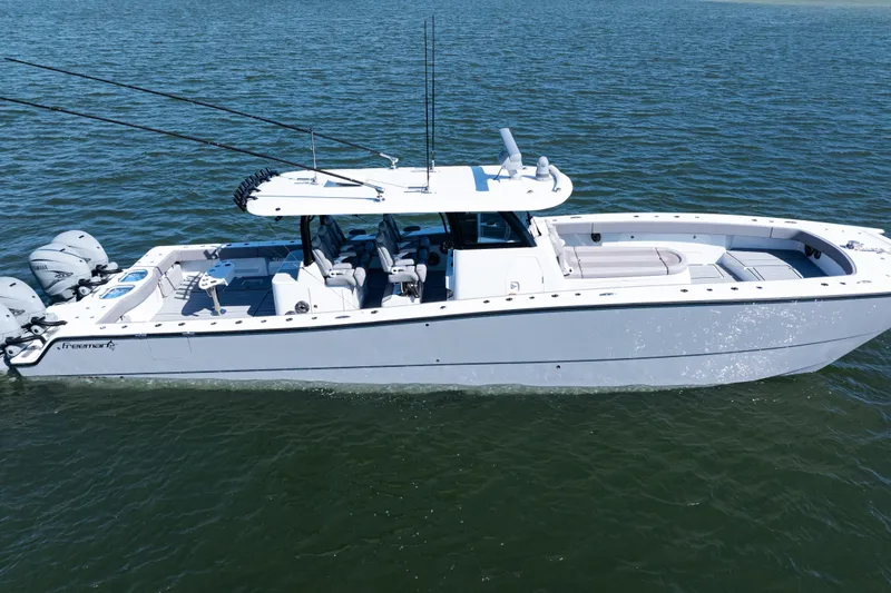  Yacht Photos Pics 2024 Freeman 47 boat on water, featuring sleek design and multiple outboard engines.