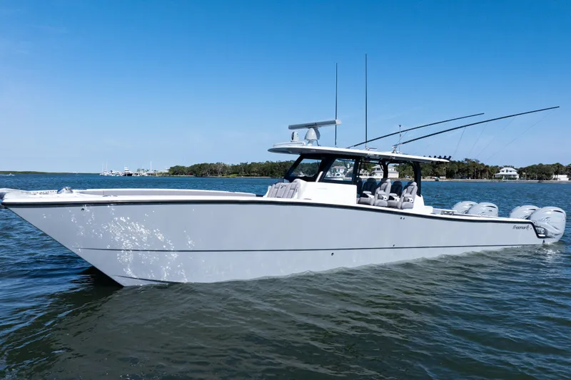  Yacht Photos Pics 2024 Freeman 47 boat on water, sleek design, multiple engines, clear blue sky.