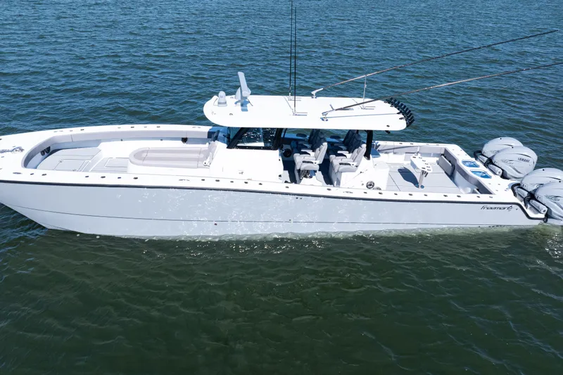  Yacht Photos Pics 2024 Freeman 47 boat on water, featuring sleek design and multiple outboard engines.