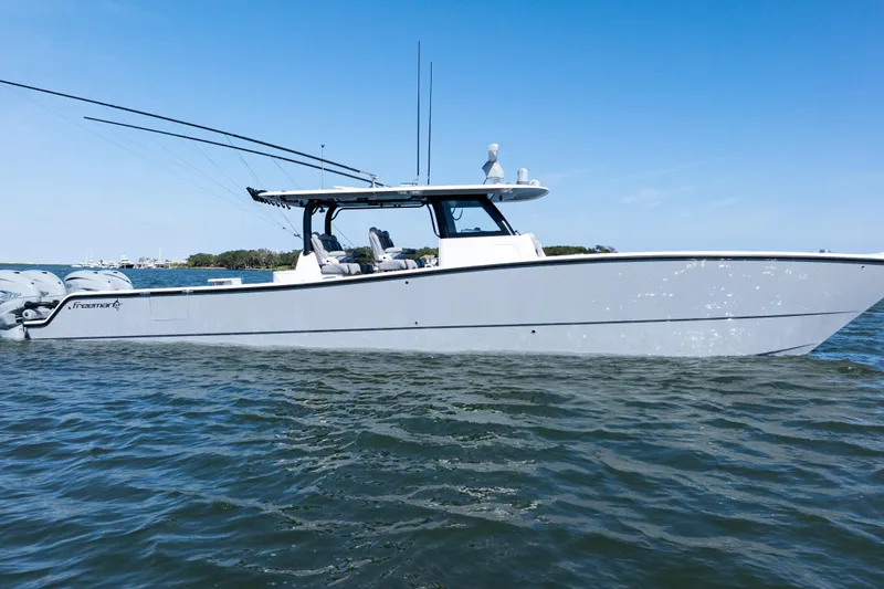  Yacht Photos Pics 2024 Freeman 47 boat on water, sleek design, clear blue sky background.