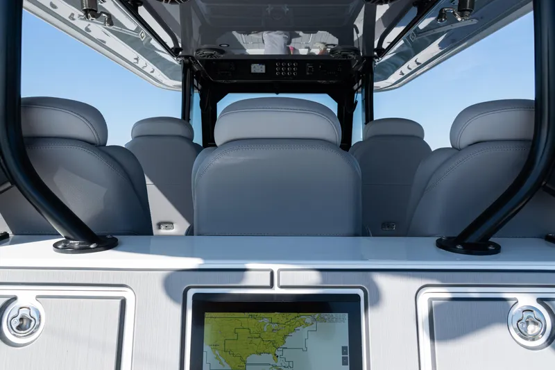  Yacht Photos Pics Interior view of 2024 Freeman 47 boat with navigation screen and seating.