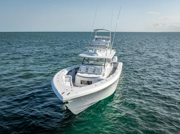  Yacht Photos Pics 2023 Yellowfin 54 boat cruising on open sea under clear sky.