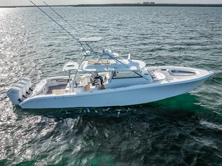  Yacht Photos Pics 2023 Yellowfin 54 boat cruising on open water, showcasing sleek design and powerful engines.