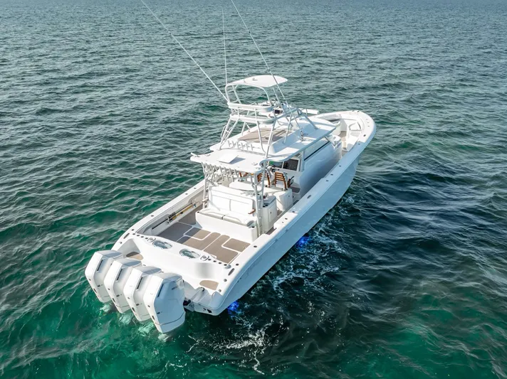  Yacht Photos Pics 2023 Yellowfin 54 boat on open water, featuring multiple outboard engines.