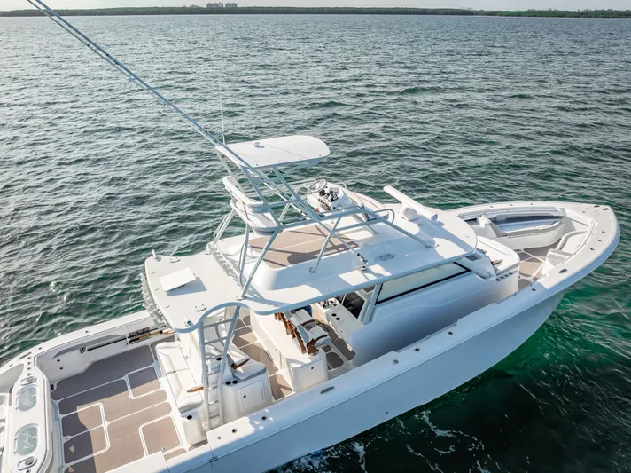  Yacht Photos Pics 2023 Yellowfin 54 boat on open water, showcasing sleek design and spacious deck.