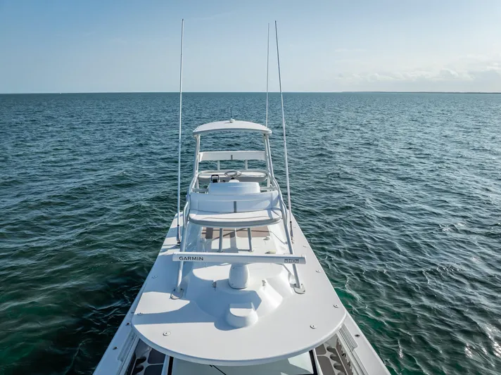  Yacht Photos Pics 2023 Yellowfin 54 boat cruising on open ocean waters under clear skies.
