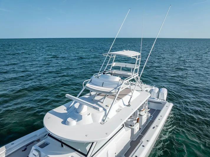  Yacht Photos Pics 2023 Yellowfin 54 boat on open sea, featuring sleek design and advanced equipment.