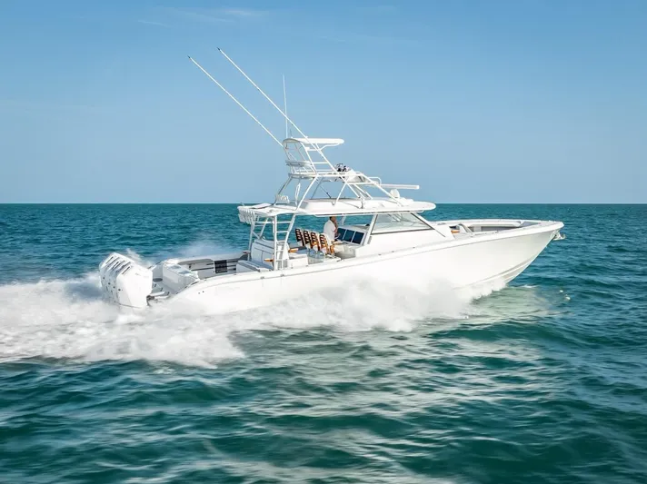  Yacht Photos Pics 2023 Yellowfin 54 boat cruising on open sea under clear blue sky.