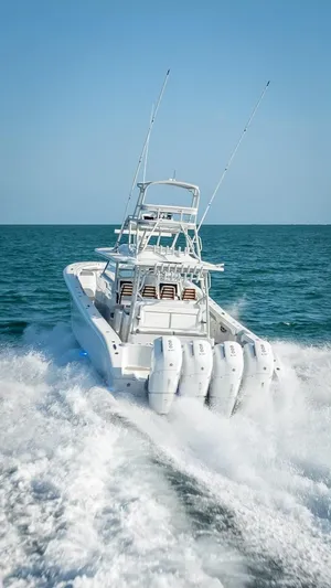  Yacht Photos Pics 2023 Yellowfin 54 boat cruising on open sea with powerful engines.