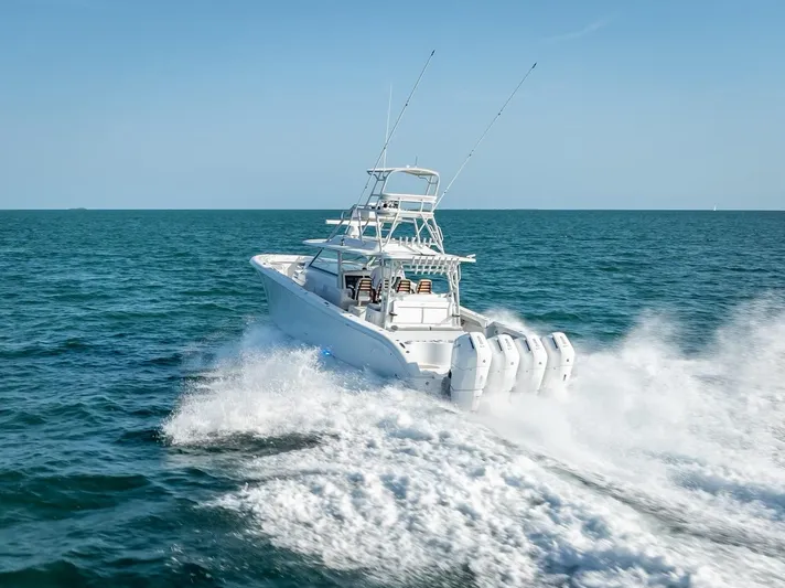  Yacht Photos Pics 2023 Yellowfin 54 boat cruising on open sea with powerful engines.