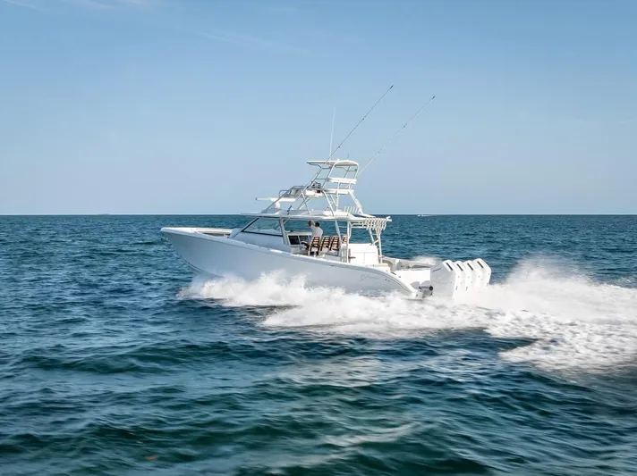  Yacht Photos Pics 2023 Yellowfin 54 boat cruising on open water, showcasing sleek design and powerful engines.