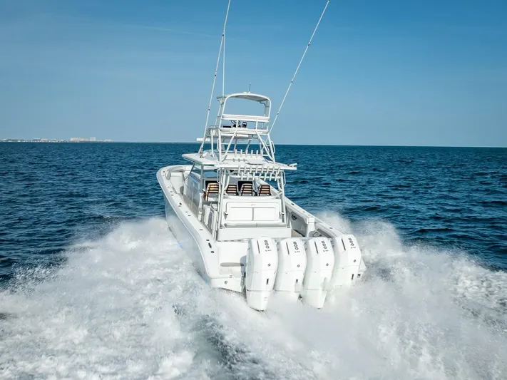  Yacht Photos Pics 2023 Yellowfin 54 boat cruising on open ocean with powerful engines.