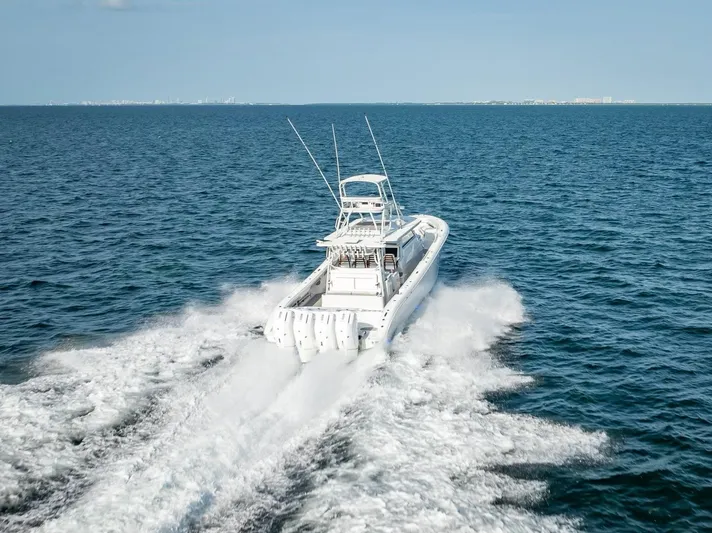  Yacht Photos Pics 2023 Yellowfin 54 boat cruising on open ocean, leaving a wake behind.