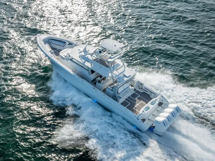  Yacht Photos Pics 2023 Yellowfin 54 boat cruising on open water, aerial view.