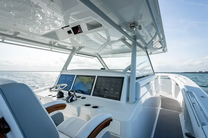  Yacht Photos Pics 2023 Yellowfin 54 boat interior with modern navigation system and ocean view.