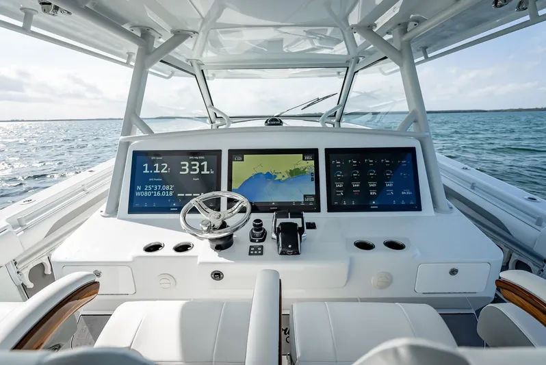  Yacht Photos Pics 2023 Yellowfin 54 boat dashboard with advanced navigation screens on open water.