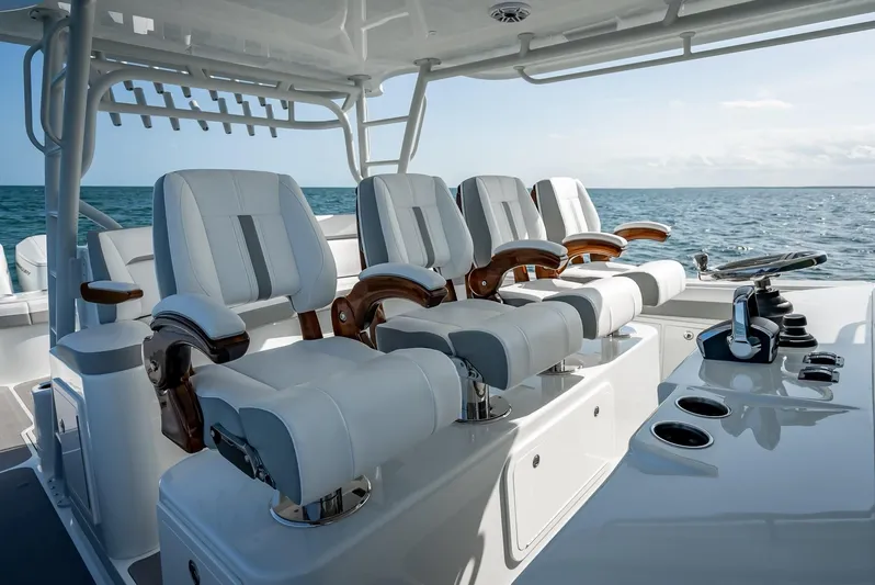  Yacht Photos Pics Luxury seating on 2023 Yellowfin 54 boat, ocean backdrop.