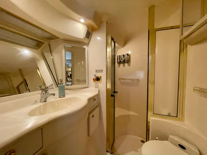No Doubts IV Yacht Photos Pics Luxurious bathroom in 1999 Sea Ray 500 Sundancer yacht with modern fixtures and shower.