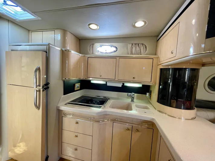 No Doubts IV Yacht Photos Pics 1999 Sea Ray 500 Sundancer yacht kitchen with modern appliances and sleek cabinetry.