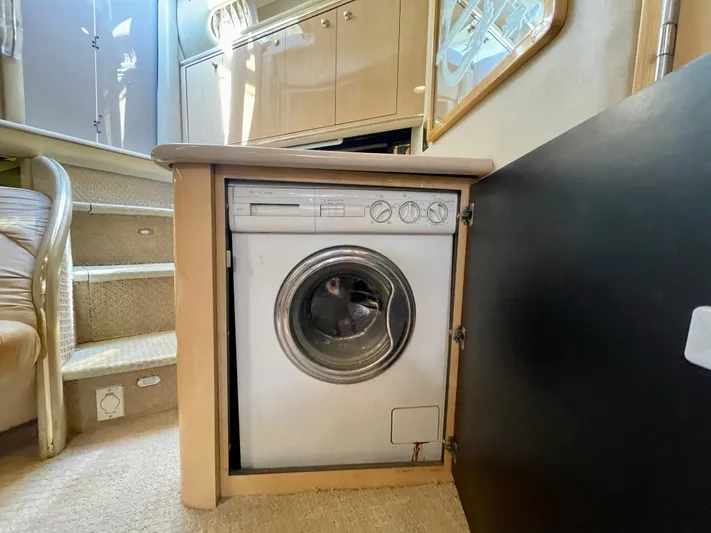 No Doubts IV Yacht Photos Pics Washing machine inside 1999 Sea Ray 500 Sundancer yacht interior, near stairs and cabinetry.