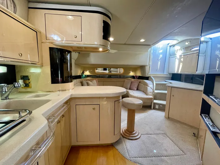 No Doubts IV Yacht Photos Pics Luxurious interior of a 1999 Sea Ray 500 Sundancer yacht, featuring a modern kitchen and seating area.