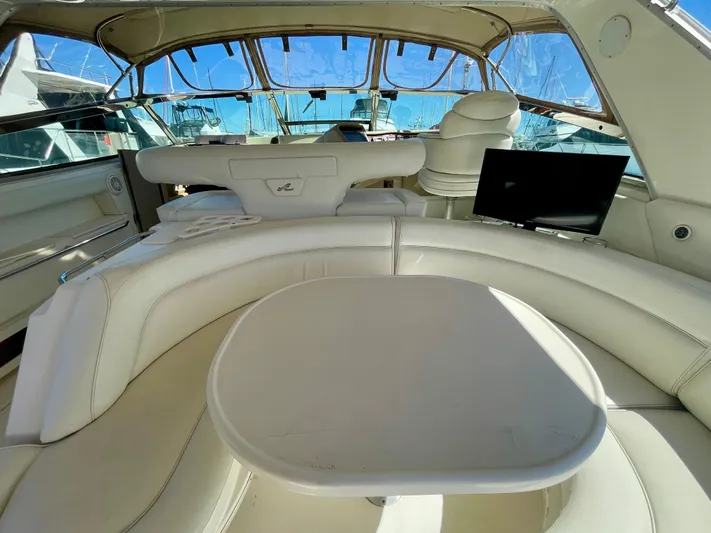 No Doubts IV Yacht Photos Pics Luxurious interior of a 1999 Sea Ray 500 Sundancer yacht with white seating and table.