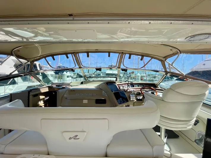 No Doubts IV Yacht Photos Pics 1999 Sea Ray 500 Sundancer yacht cockpit with luxurious white seating and modern controls.