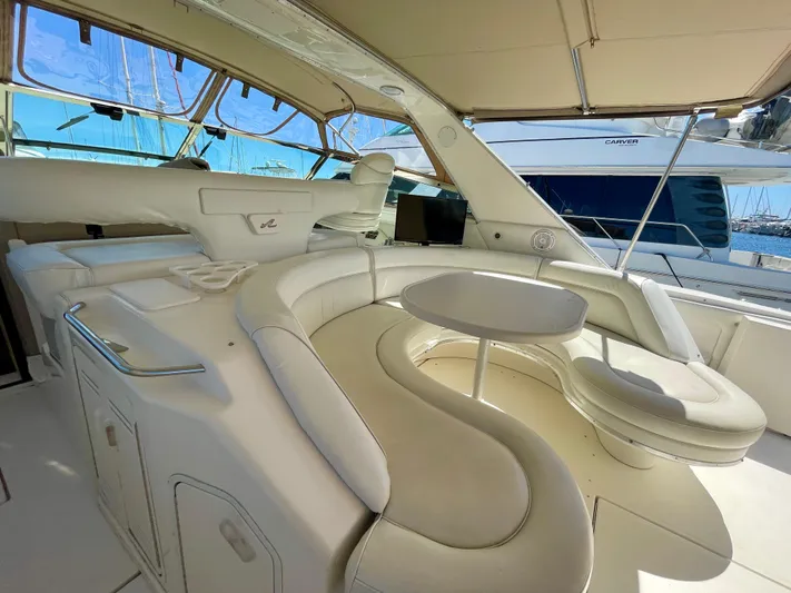 No Doubts IV Yacht Photos Pics Luxurious 1999 Sea Ray 500 Sundancer yacht interior with elegant white seating and table.