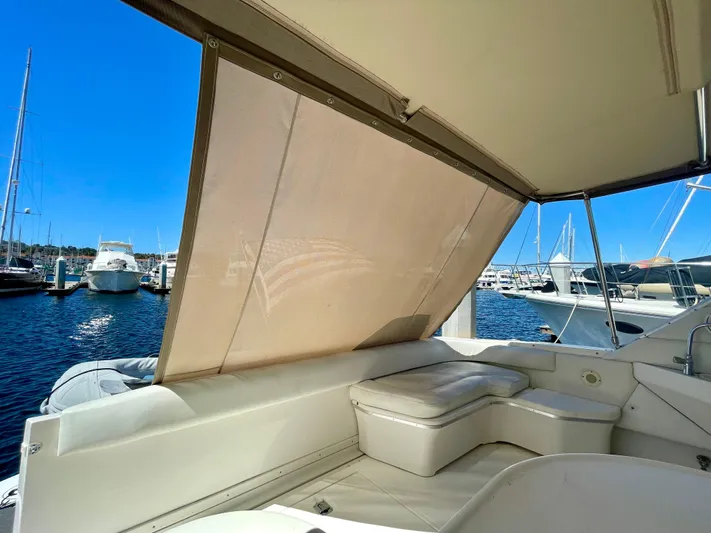 No Doubts IV Yacht Photos Pics 1999 Sea Ray 500 Sundancer yacht interior with sunshade, docked at marina.