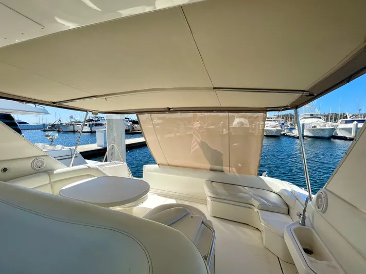 No Doubts IV Yacht Photos Pics 1999 Sea Ray 500 Sundancer yacht interior with seating and table, docked at marina.