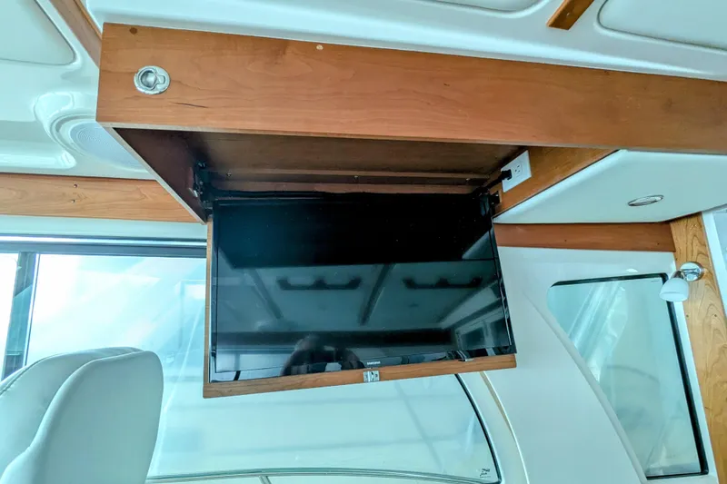  Yacht Photos Pics 2024 Back Cove 39O yacht interior with retractable TV in wooden cabinet.