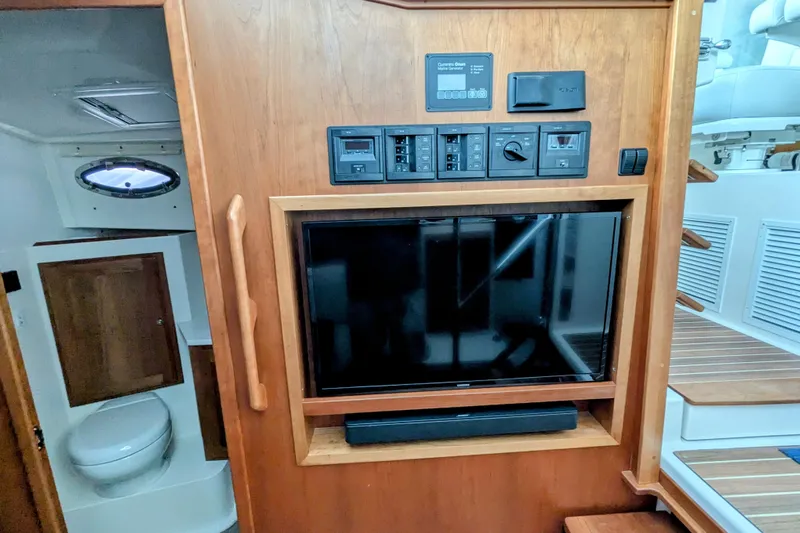  Yacht Photos Pics 2024 Back Cove 39O interior with TV, control panel, and bathroom view.