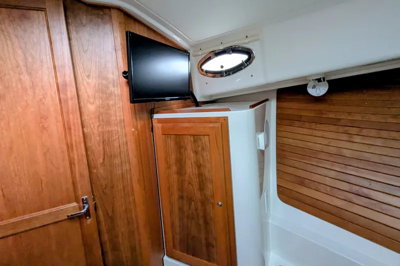  Yacht Photos Pics 2024 Back Cove 39O interior with wood paneling and mounted TV.