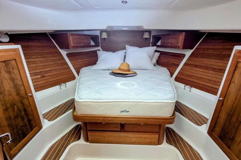  Yacht Photos Pics 2024 Back Cove 39O cabin interior with bed, wooden accents, and cozy decor.