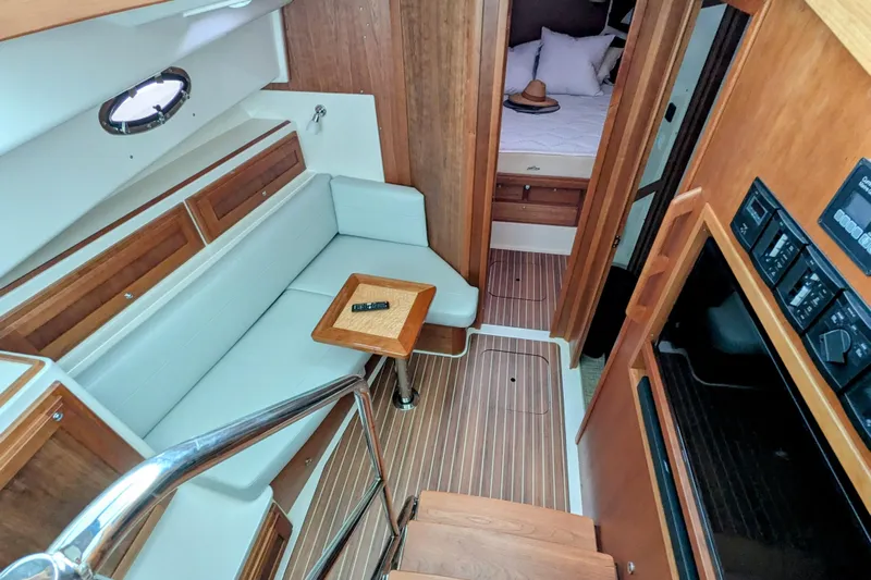  Yacht Photos Pics 2024 Back Cove 39O interior with wood accents, seating area, and cozy cabin.
