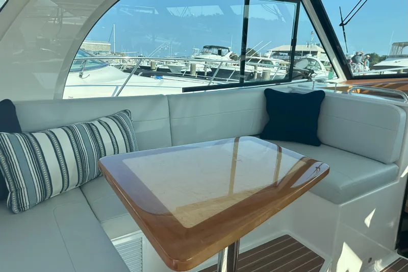  Yacht Photos Pics Luxurious interior of 2024 Back Cove 39O yacht with elegant seating and wooden table.
