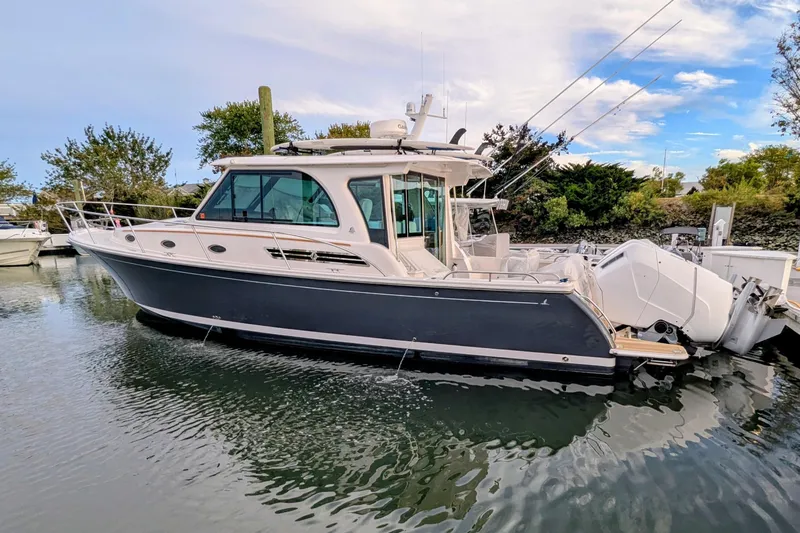  Yacht Photos Pics 2024 Back Cove 39O boat docked in calm waters, showcasing sleek design and modern features.