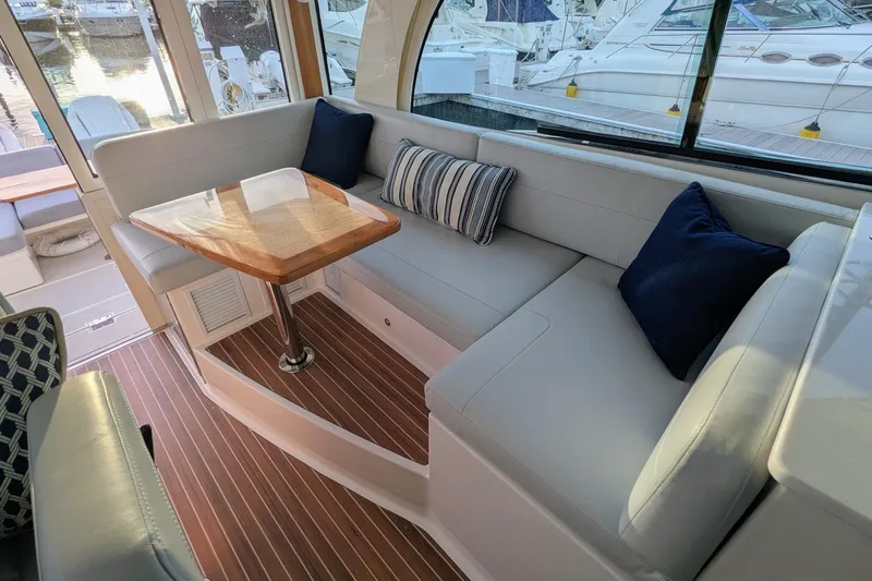  Yacht Photos Pics Luxurious interior of 2024 Back Cove 39O yacht with elegant seating and wooden table.