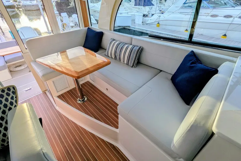  Yacht Photos Pics Luxurious interior of 2024 Back Cove 39O yacht with elegant seating and wooden table.