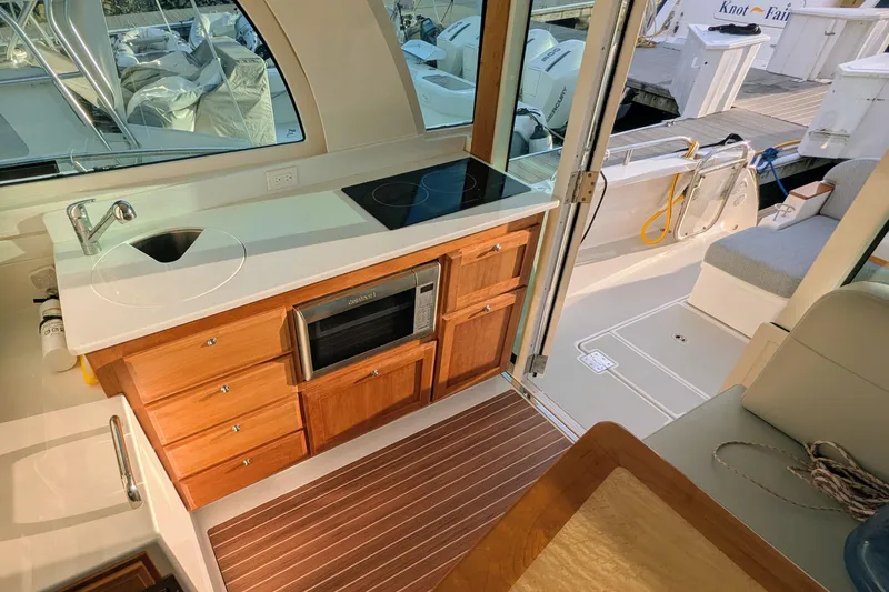  Yacht Photos Pics 2024 Back Cove 39O yacht interior with kitchenette, featuring sink, stove, and microwave.