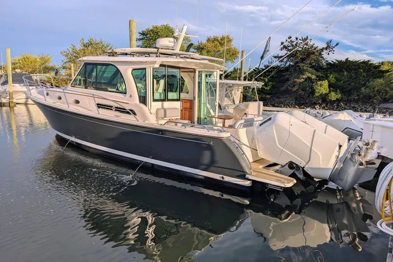  Yacht Photos Pics 2024 Back Cove 39O boat docked in serene marina setting.